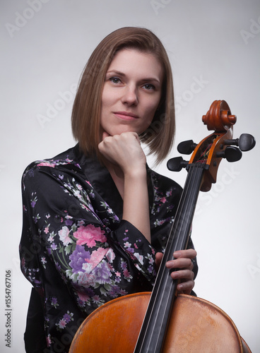 Portrait of woman in floral robe holding cello