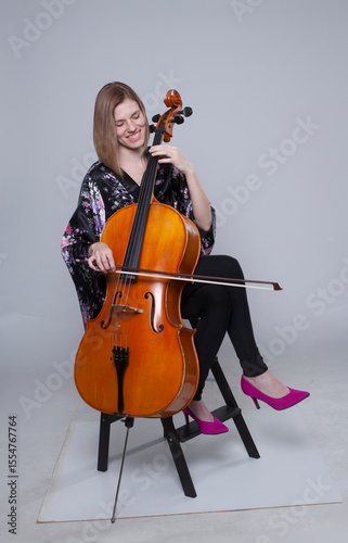 Woman with Cello, Smiling, Wearing Floral Robe and Pink Heels