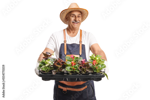 Man with an apron and straw hat holding a tray with flower pots