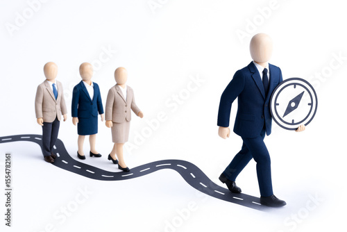 Businesspeople in formal attire walking along winding road with leader holding compass symbolizing agile leadership concept