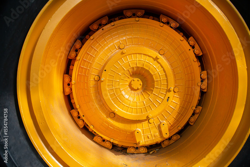 The wheel disc of a large mining car is yellow. Transport construction industry.