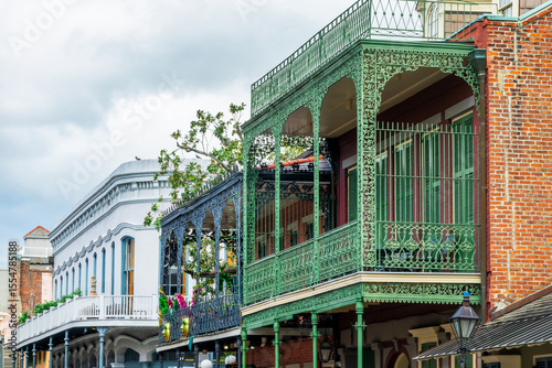 Balconies with intricate ironwork at a building in a street of the French Quarter, New Orleans architecture, Louisiana