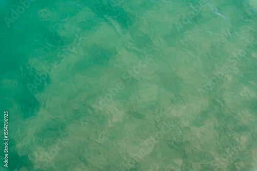 Abstract texture of a swimming pool water reflecting white light