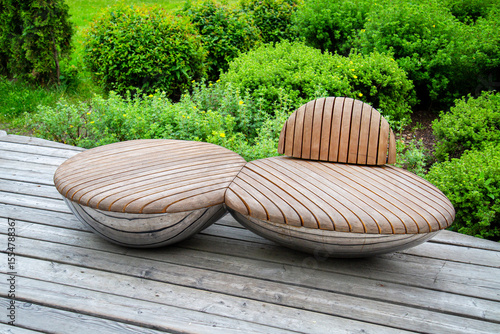 Original oval shaped wooden chairs on a bright sunny day. Agriculture, Urban landscaping.