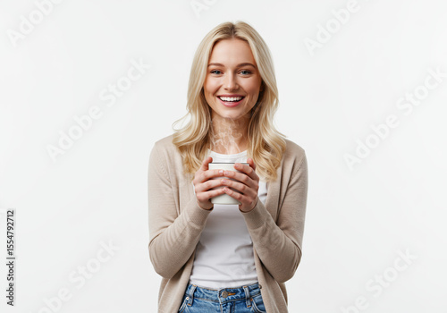 Happy blonde woman smiles warmly while holding a coffee cup against a white background.