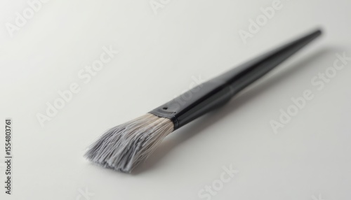 Close-Up of a High-Quality Paintbrush on a White Surface, Showcasing Intricate Details and Texture