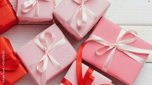 colorful wrapped gifts decorated with ribbons arranged on a wooden background, perfect for celebrations, parties, or special occasions emphasizing joy and generosity