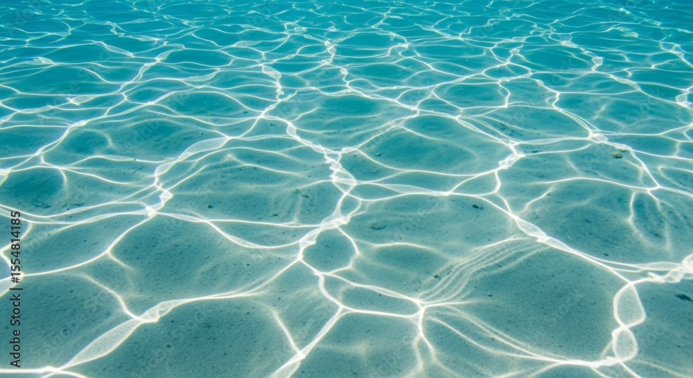 Fototapeta premium Abstract underwater sunlight patterns on a sandy seabed