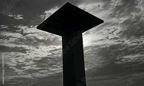Silhouette of a tower against a cloudy sky