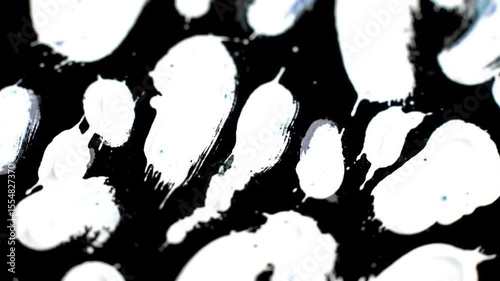 Dynamic black and white paint strokes art, creating a visually stunning contrast background video