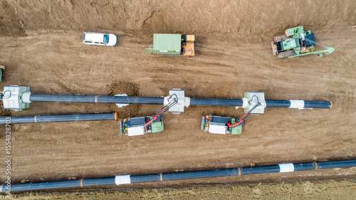 Gas and oil pipeline construction. Pipes welded together. Big pipeline is under construction. Aerial view