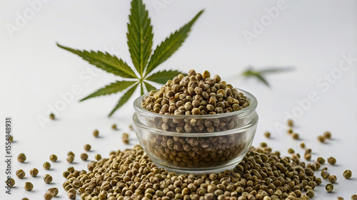 Closeup of hemp seeds with cannabis plant on white background, natural and fresh composition