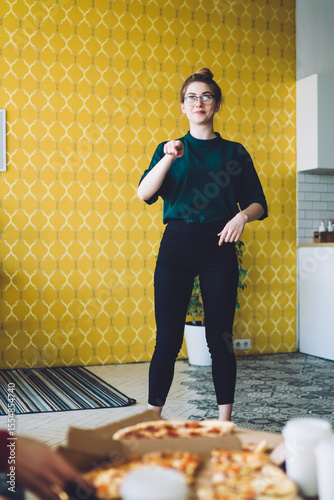 Thoughtful woman recreating with friends in flat