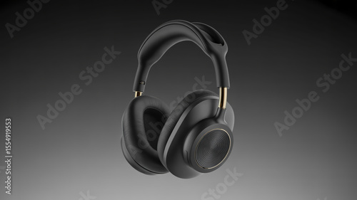 A pair of black over ear headphones with gold accents floating in a gray gradient background