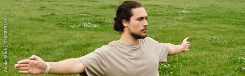 Sporty man exercising outdoors on a bright sunny day in a lush green field