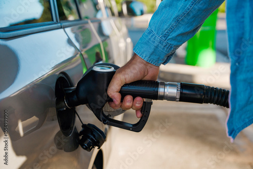 Fueling up car at modern gas station with diesel or petrol, capturing the essence of everyday travel and convenience