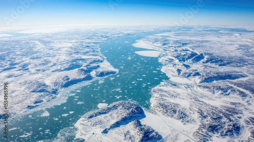 Vibrant turquoise river winds through pristine ice and snow, showcasing breathtaking aerial views of untouched nature
