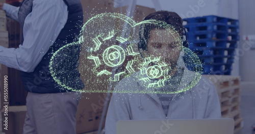 Cloud computing image over person working on laptop in office setting