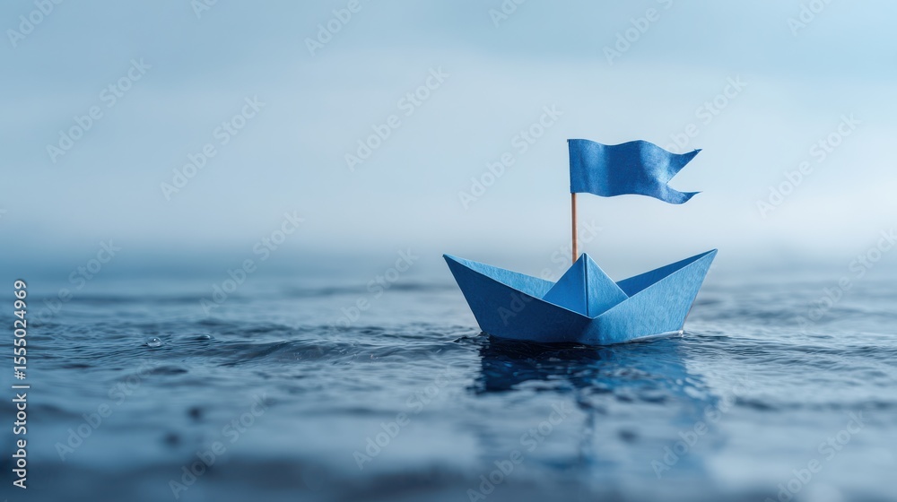 Obraz premium Blue paper boat with flag.