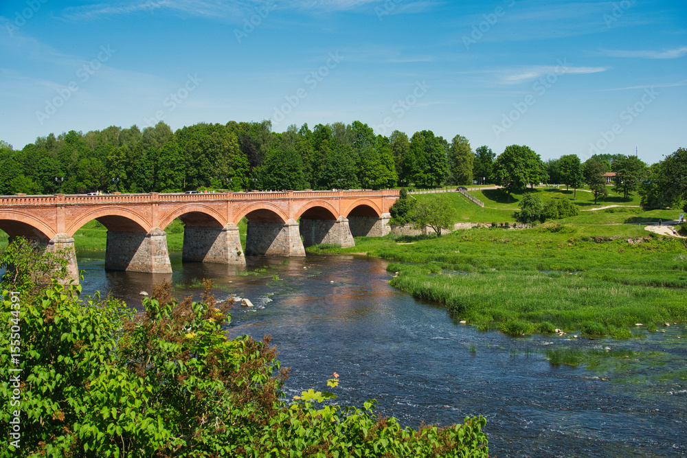 Fototapeta premium Historic Brick Bridge Over the Venta River in Kuldīga, Latvia