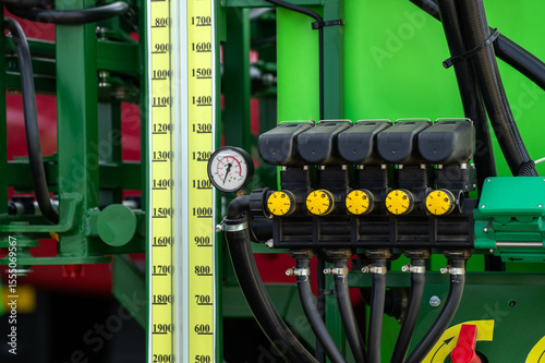 A green machine with a yellow gauge and black valves