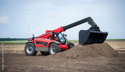 A red and black tractor is digging a hole in the dirt