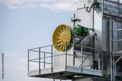 A large fan is mounted on a metal structure