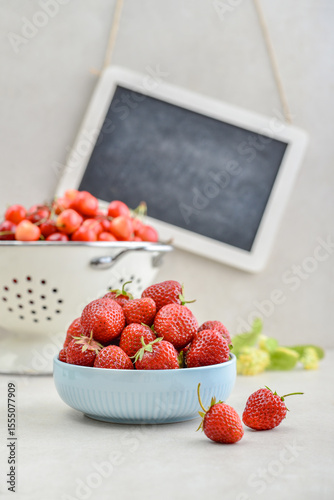 Strawberry and sweet cherry with framed chalkboard