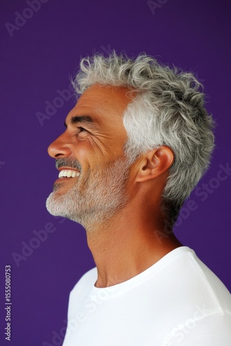 Purple solid background. A fashionable and chic male posing elegantly. Elegant men's soft perm haircut - midlife arabian man with short hair. Conceptual art of style for aging men.