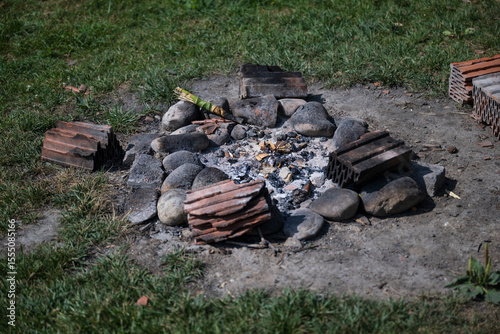 Firesite outdoors in the nature, remains of campfire