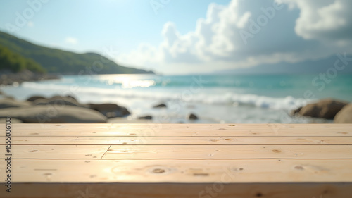 Warm sunlight highlights textured wooden planks in sharp focus, blending into a dreamy blurred background of blue waves, rocky coastlines, lush hills, and a bright sky with fluffy white clouds.