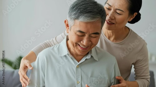 happy elderly couple enjoying intimate moment together at home with smiles and affection, showcasing love and companionship in a cozy living space