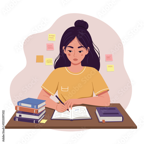 Young woman studying and taking notes at a desk with books  