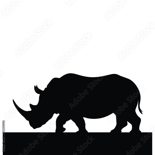 Rhino charging silhouette on dry land vector illustration on isolated black and white background