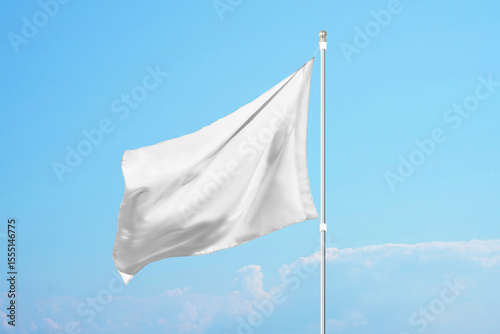 Empty white flag in the wind on clear blue sky, ideal for promotional design, customization or national identity mockups