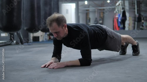 European man doing plank exercise in gym. sport. man standing on elbows in gym workout
