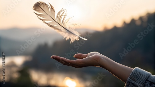 Hand letting go of a feather — it floats mid-air, paused