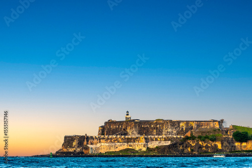 Sunrise view of El Morro fort from the water in Old San Juan Puerto Rico  photo
