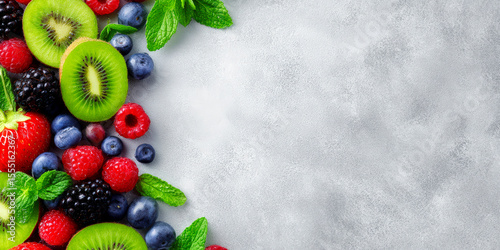 Fresh Colorful Assortment of Mixed Berries and Kiwi on Grey Background