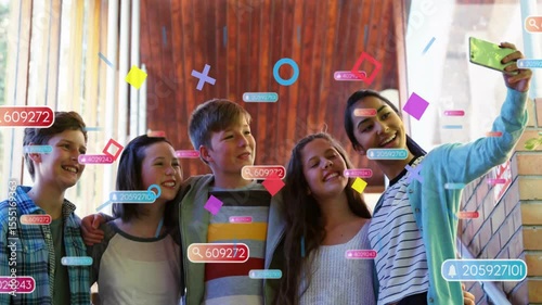 Friends raising green smartphone taking selfie for social media, generating floating AR tags