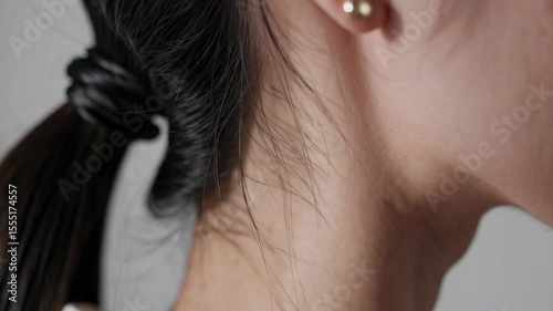 Wallpaper Mural close-up of a Japanese woman's ear wearing a small gold stud earring Torontodigital.ca