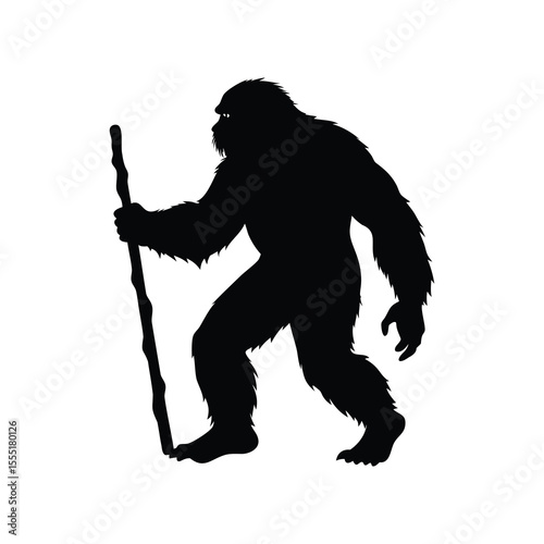 Silhouette of Bigfoot creature walking with a walking stick in the wilderness