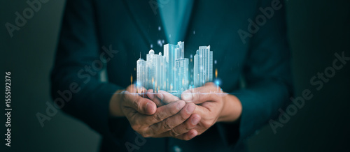 Businessman holding virtual real Estate showing Investment and Market Growth Concept or Analyzes real estate market development growth trends . Real estate and Property insurance and security concept.