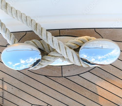 Bollard (cleat) with mooring line on superyacht. Mooring gear on yacht. Superyacht equipment. Side view.