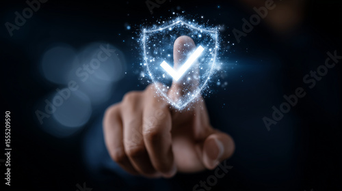 Close-up of a hand touching a holographic shield with a checkmark, representing digital security systems, privacy technology, and virtual authentication in a tech-driven world secu