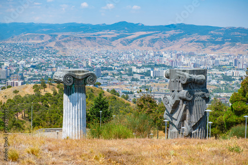Columns of the Monument of the Chronicle of Georgia with a view of the city