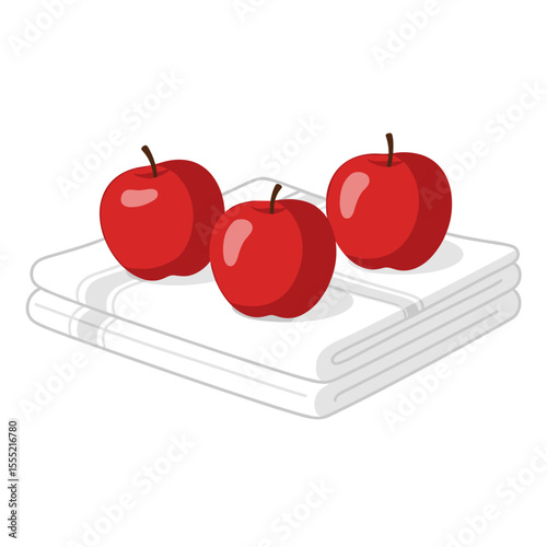 Three red apples placed on white napkins in a flat lay style  