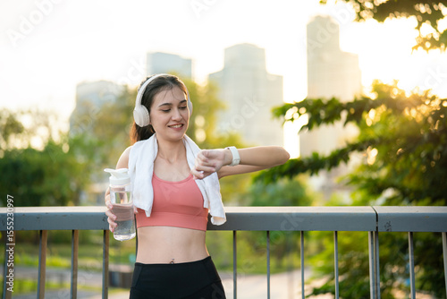 Young woman checking fitness progress on smartwatch
