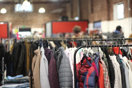 pessoas comprando em feira de segunda mao de produtos texteis em economia circular e consumo consciente