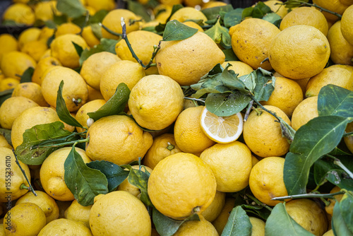 a pile of lemons is waiting to be bought at the market